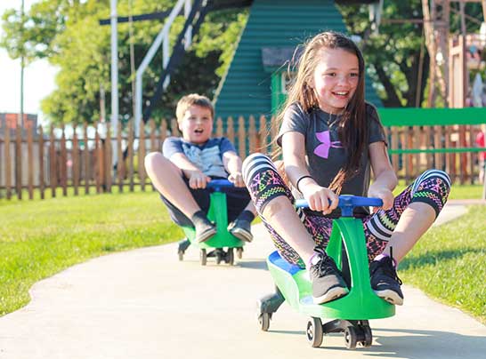 Birthday guests riding the petal cars